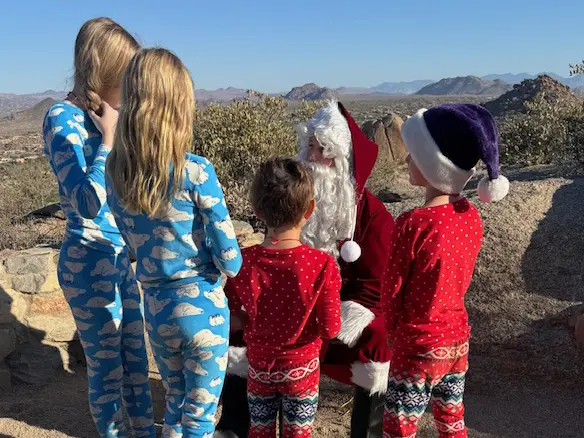 Kids in PJs gathered around Santa